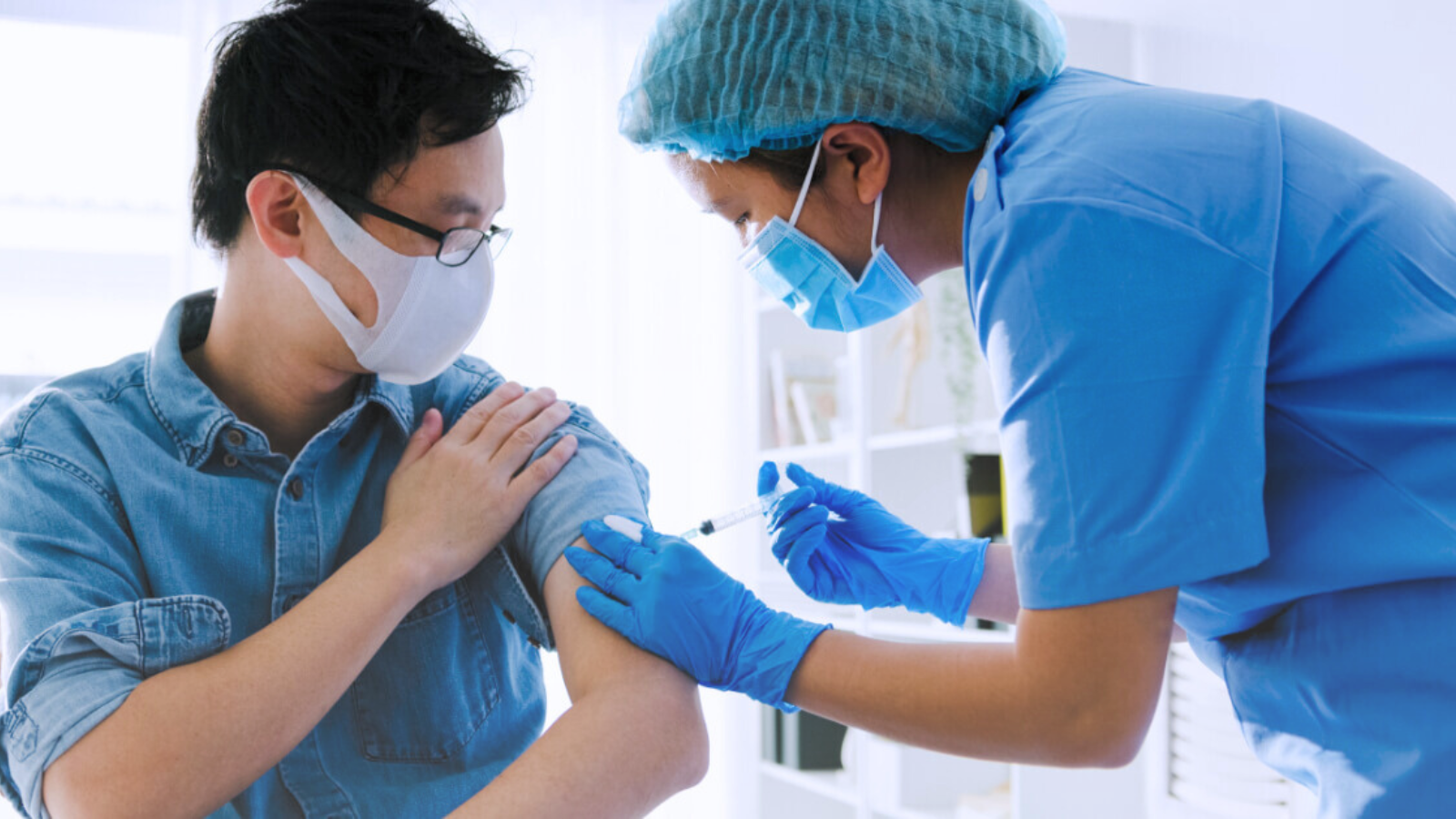 A nurse administers a vaccination to a patient in a clinical setting, ensuring proper technique and care.