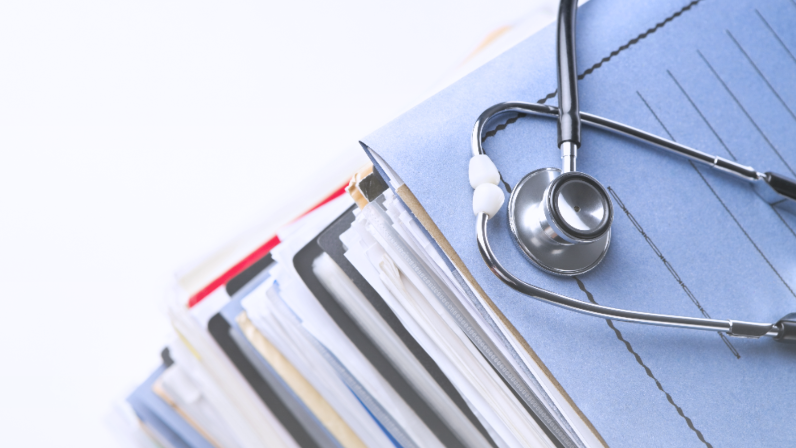 A stethoscope rests on a folder, symbolizing medical documentation and healthcare.