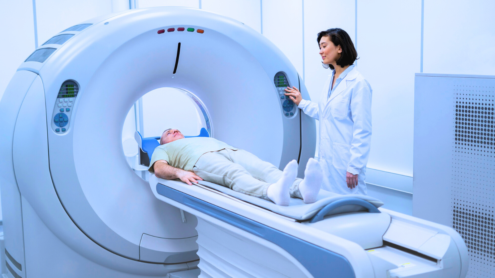 A woman lies on an MRI machine, preparing for a medical imaging procedure in a clinical setting.